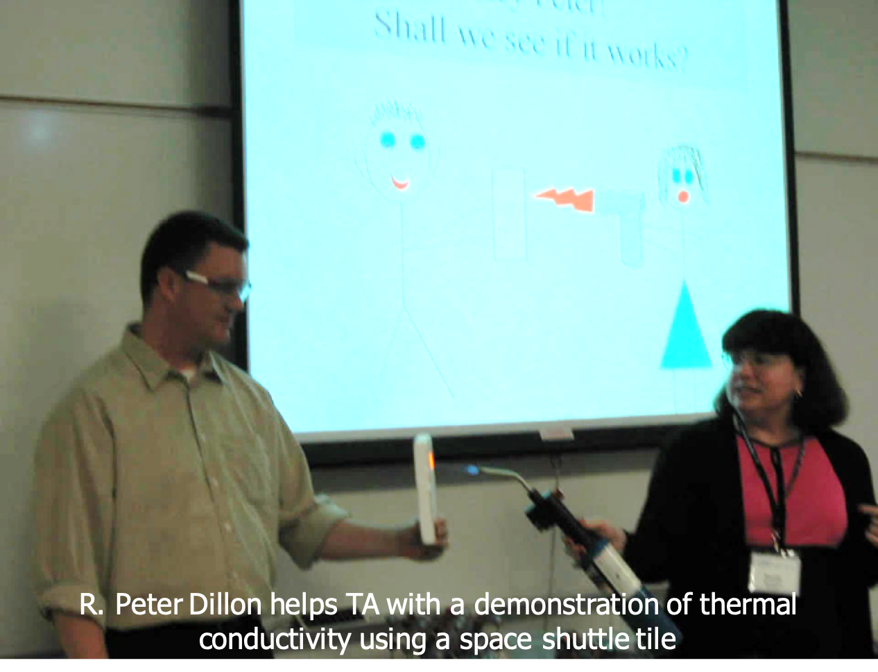 R. Peter Dillon helps TA with a demonstration of thermal conductivity using a space shuttle tile
